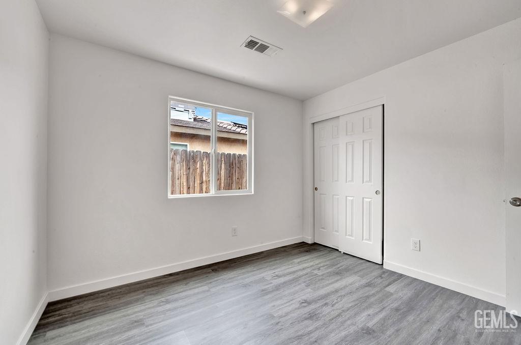 Undisclosed Address McFarland, CA 93250 - Photo 19 of 35 a view of an empty room with wooden floor and a window