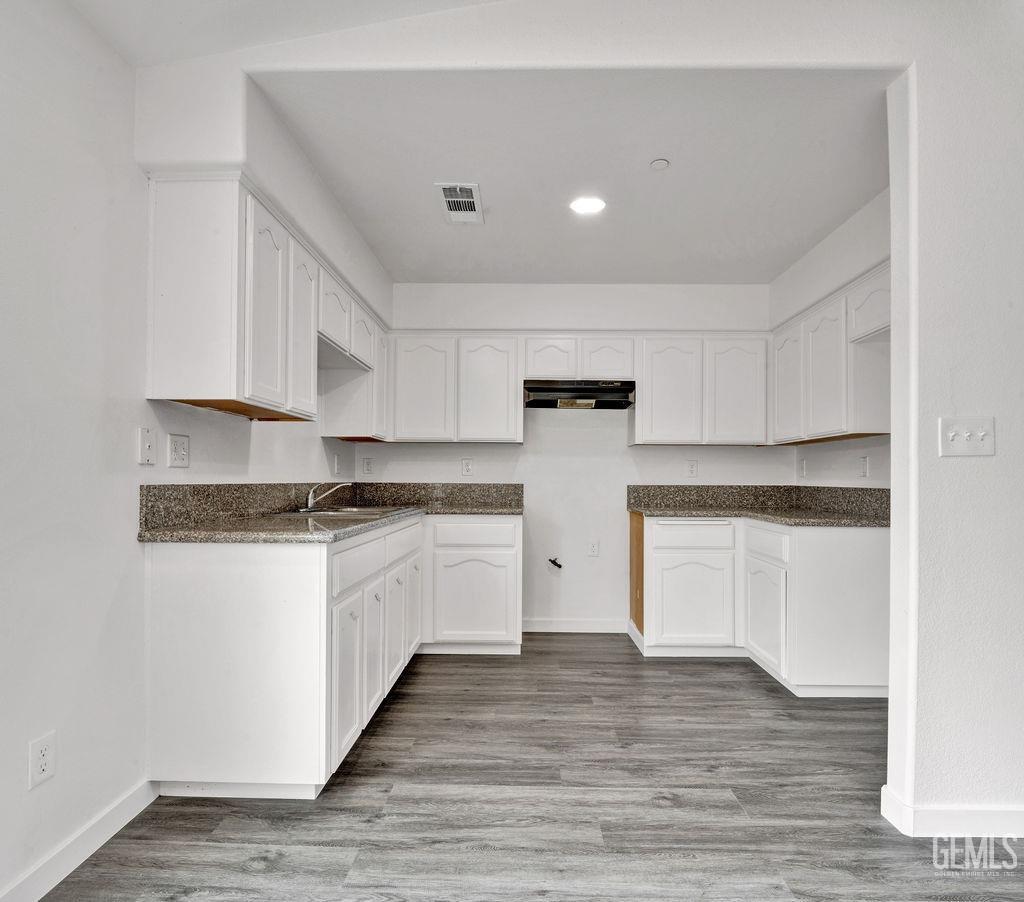 Undisclosed Address McFarland, CA 93250 - Photo 8 of 35 a kitchen with granite countertop white cabinets and white appliances