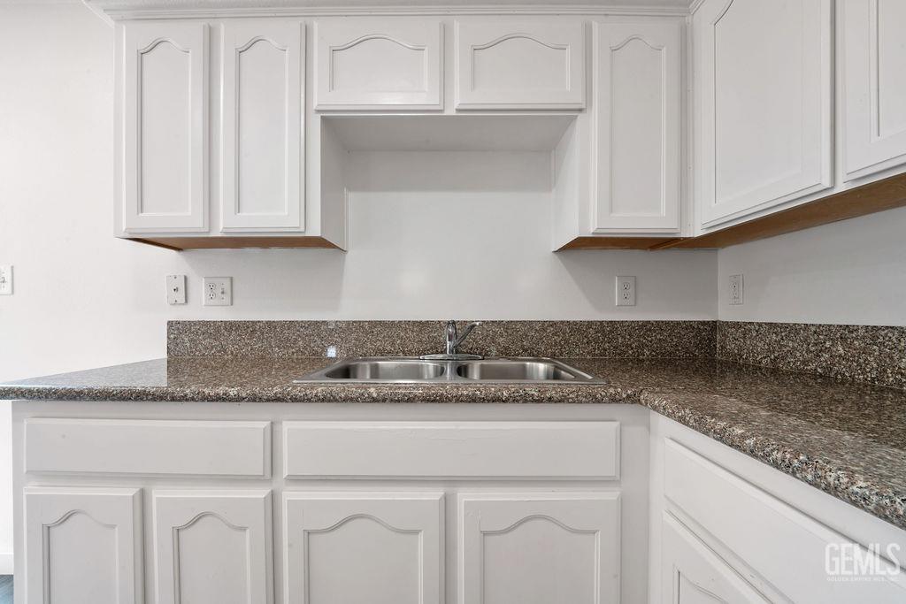 Undisclosed Address McFarland, CA 93250 - Photo 9 of 35 a kitchen with granite countertop white cabinets and a granite counter tops