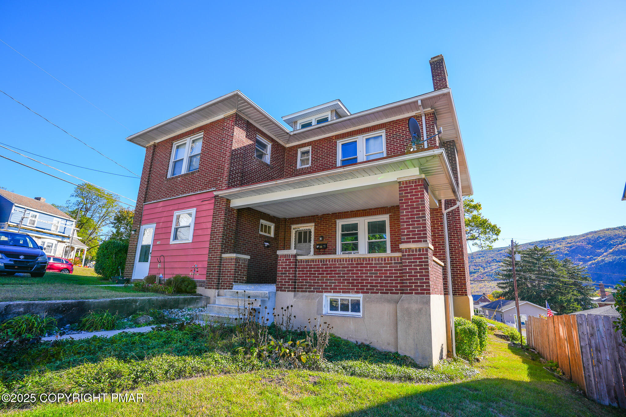 a front view of house with yard and green space