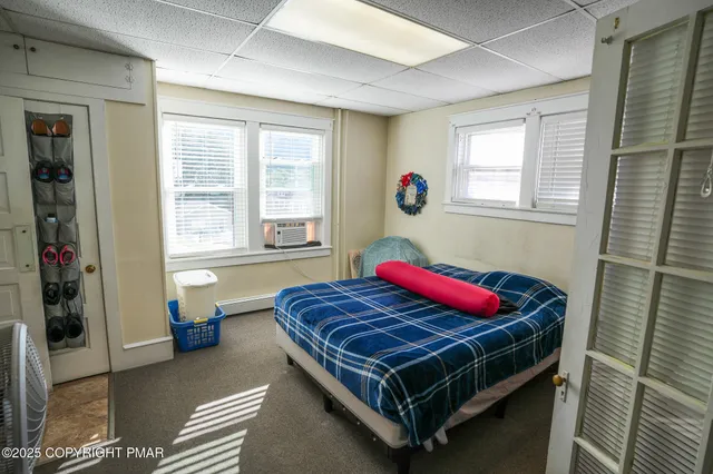 a bedroom with a bed and window
