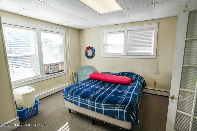 a kitchen with stainless steel appliances a refrigerator and a wooden floor