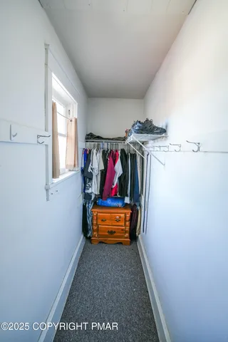 a kitchen with stainless steel appliances a table and chairs in it