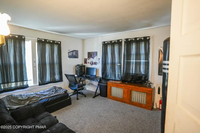 a kitchen with stainless steel appliances granite countertop a refrigerator a sink dishwasher a stove and a dining table with wooden floor