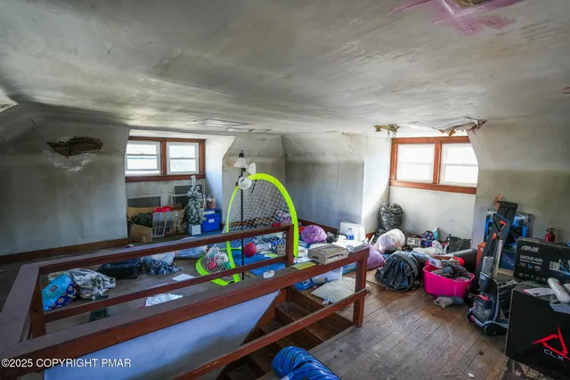a living room with furniture a flat screen tv and a couch