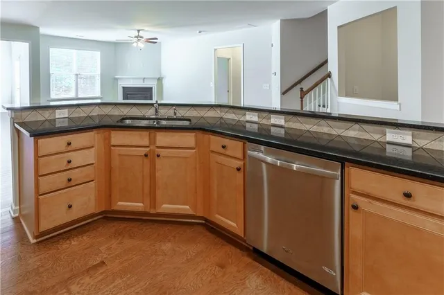 an empty room with a window and a ceiling fan