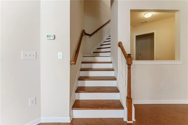 an empty room with a ceiling fan and closet area