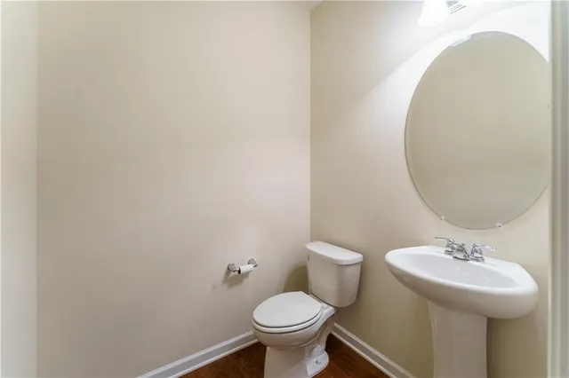 a bathroom with a granite countertop double vanity sink a vanity and a mirror