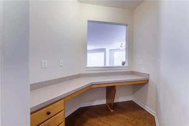 an empty room with a ceiling fan and a window