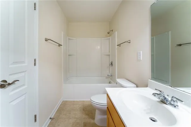 an empty room with fan and entryway