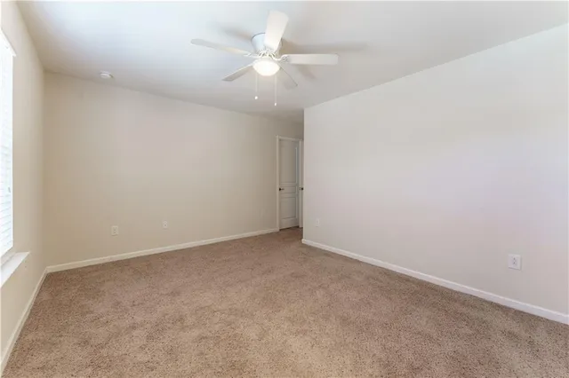 a spacious bathroom with a granite countertop sink and a mirror