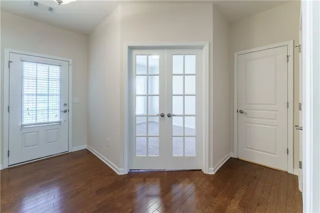 a kitchen with stainless steel appliances granite countertop a sink a stove a refrigerator a washer dryer and white cabinets