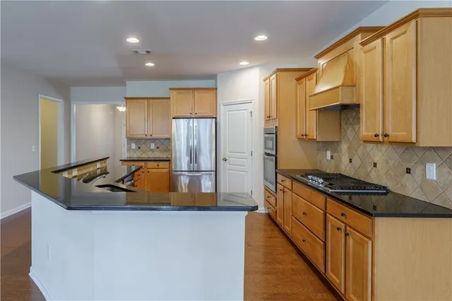 a stove top oven sitting inside of a kitchen