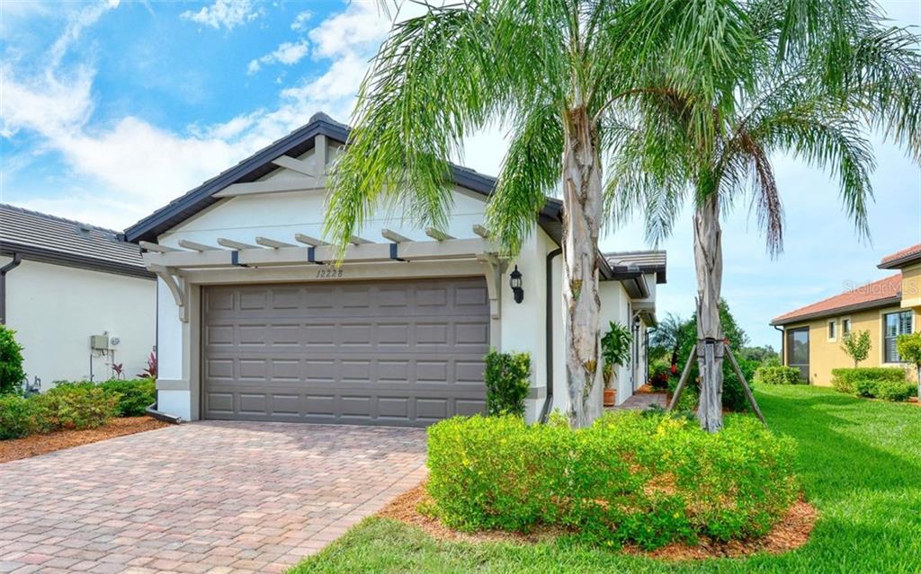 12228 Marsh Pointe Road Sarasota, FL 34238 - Photo 1 of 1 a front view of house with small garden