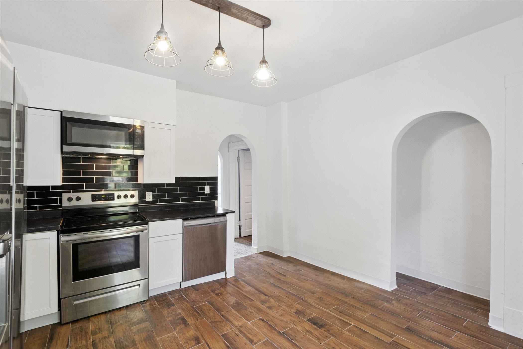 918 South 3rd Street Rockford, IL 61104 - Photo 20 of 27 a kitchen with stainless steel appliances and wooden floor