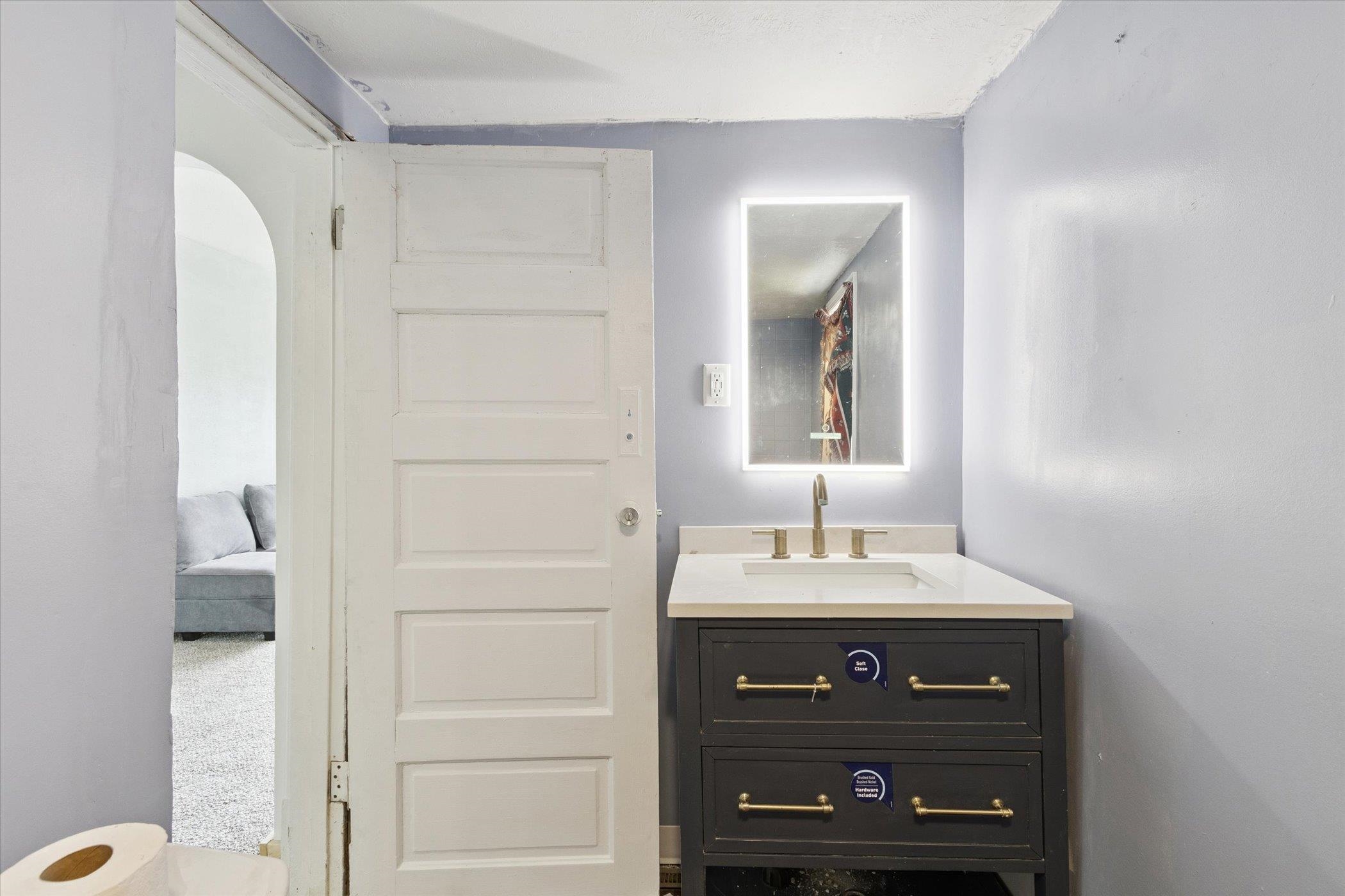 918 South 3rd Street Rockford, IL 61104 - Photo 25 of 27 a bathroom with a sink vanity and a mirror