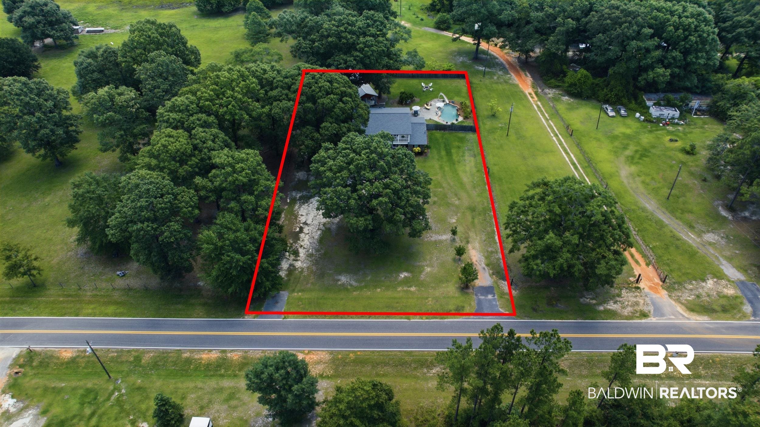 51620 Robert White Road Bay Minette, AL 36507 - Photo 79 of 81 Aerial perspective showcasing a single-story residence with a dark-pitched roof and a dedicated driveway