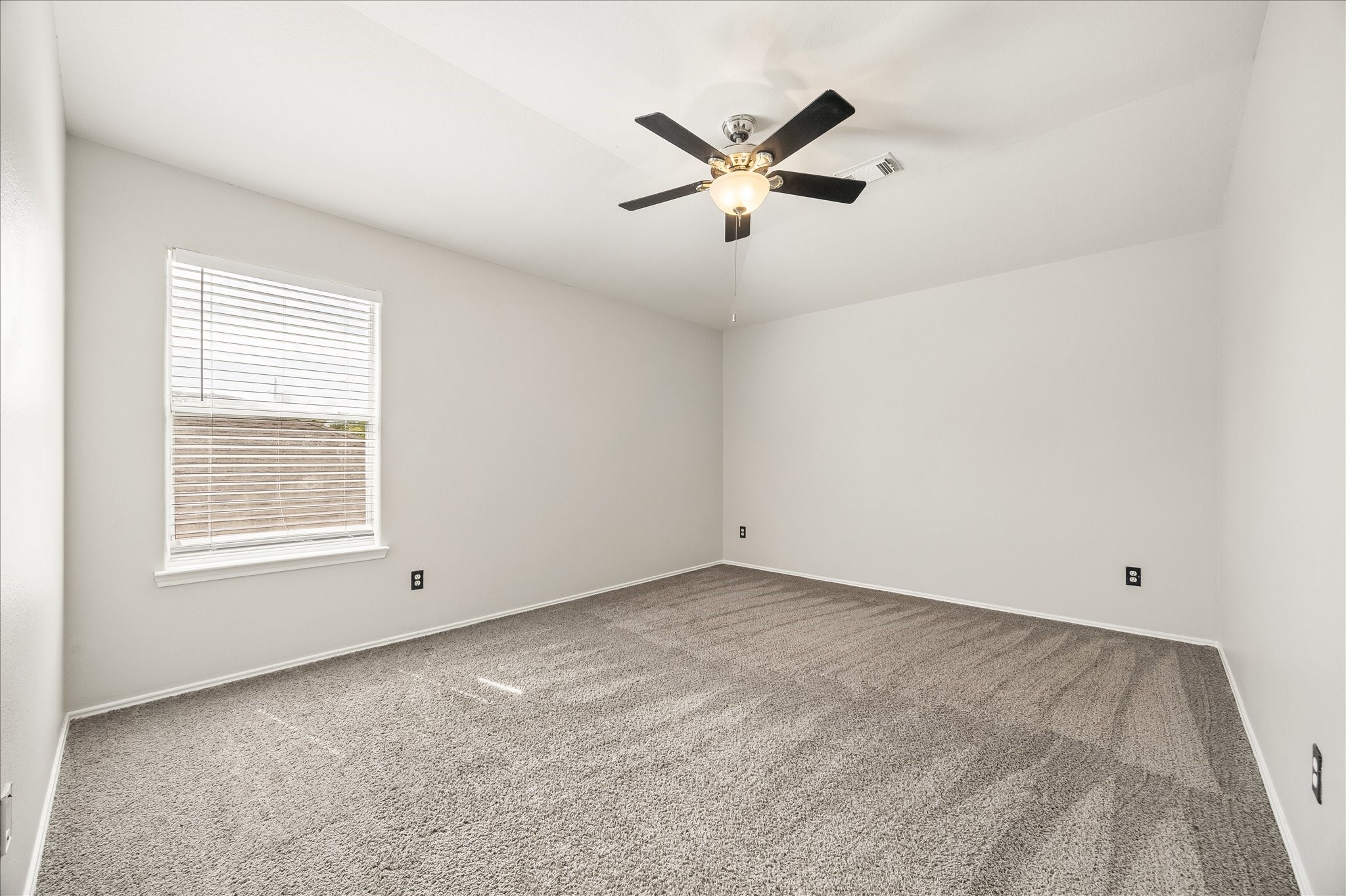 223 Sunset Colony Drive Rosharon, TX 77583 - Photo 28 of 50 A cozy spot for family or guests, this upstairs bedroom offers soft neutral carpet, fresh paint, a cooling fan and large closet, with the full bath just steps away.