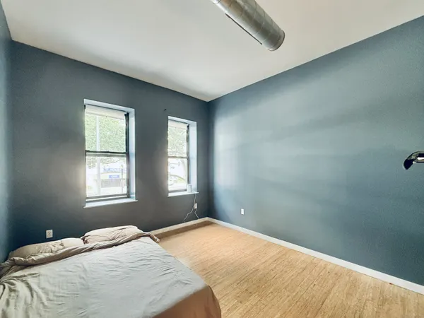 a bedroom with a bed and a window