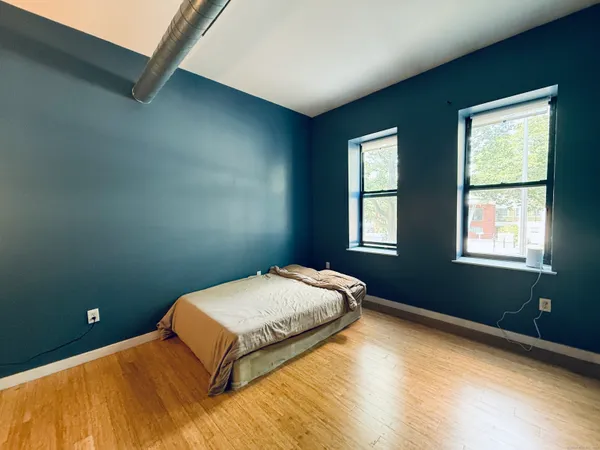 a bedroom with a bed and window
