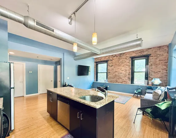 a bathroom with a granite countertop sink and a large mirror