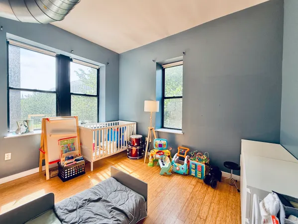 a bedroom with furniture and a large window