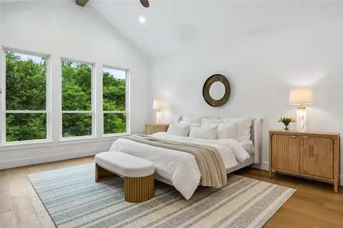 a bedroom with a large bed and a large window