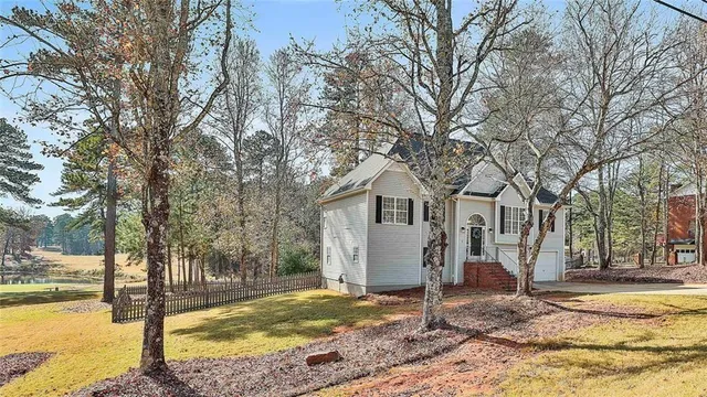 a view of a house with snow on the side of the road