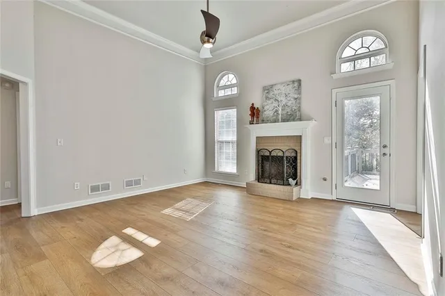 a view of a kitchen with refrigerator and wooden floor