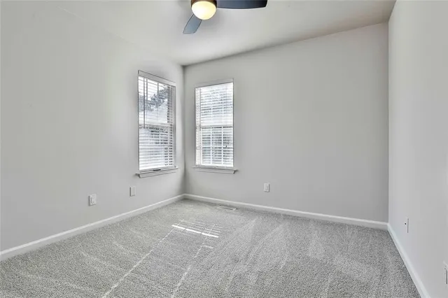 a view of backyard with deck and outdoor seating