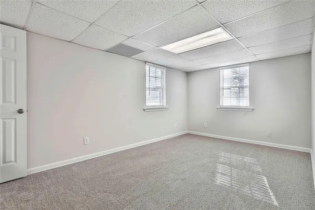 a view of a patio with table and chairs and wooden fence