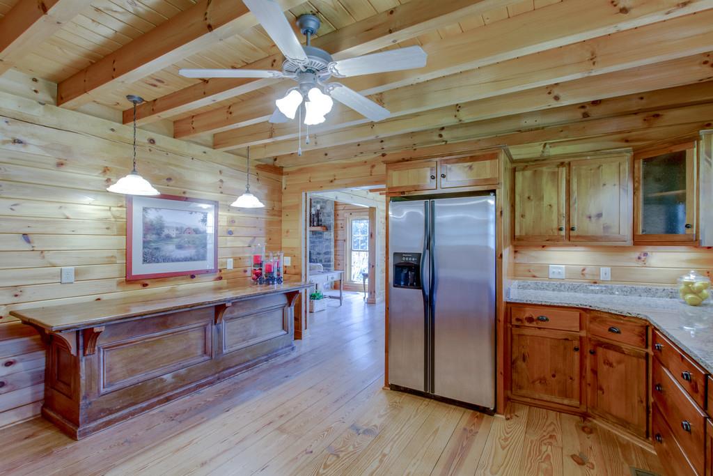 1567 Dillon Road Milton, TN 37118 - Photo 11 of 30 a kitchen with stainless steel appliances granite countertop a refrigerator a sink dishwasher a stove and white countertops with wooden floor