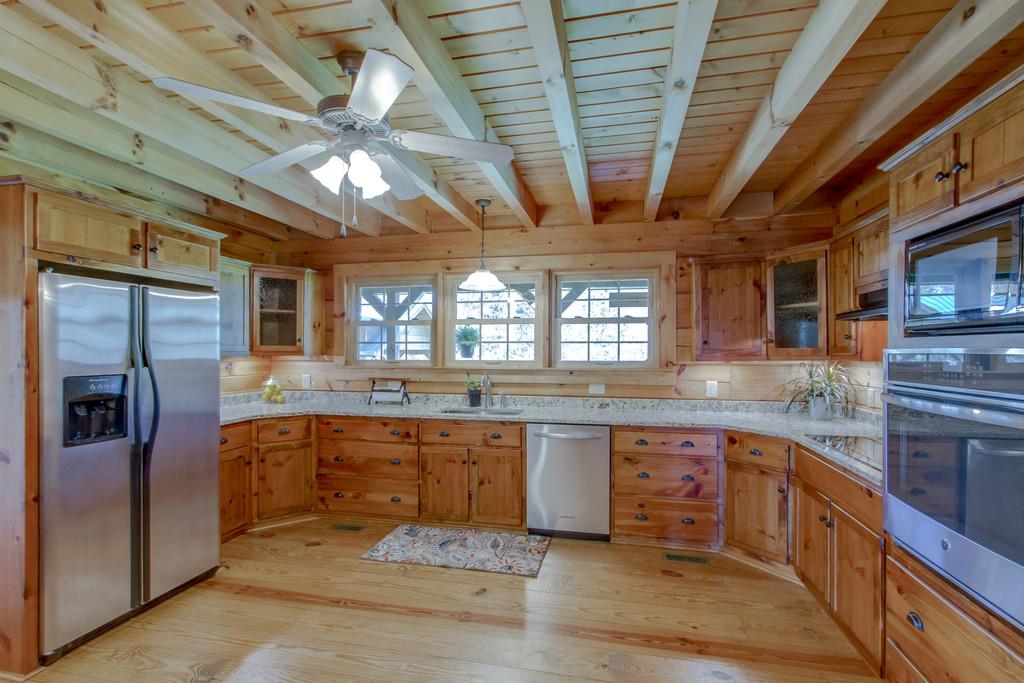 1567 Dillon Road Milton, TN 37118 - Photo 10 of 30 a large kitchen with a large counter space a sink appliances and cabinets