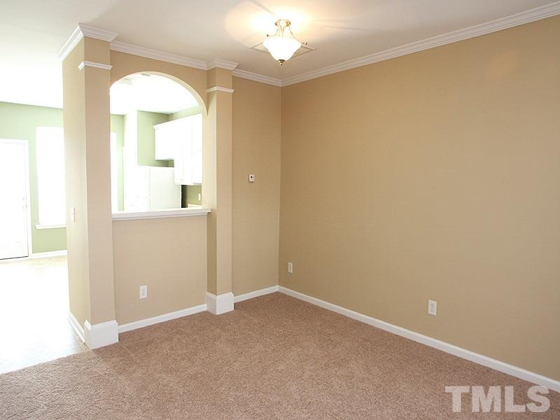 8458 Reedy Ridge Lane Raleigh, NC 27613 - Photo 4 of 12 an empty room with a bathroom