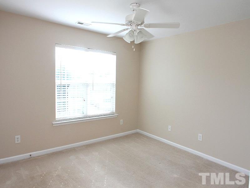 8458 Reedy Ridge Lane Raleigh, NC 27613 - Photo 7 of 12 an empty room with a window