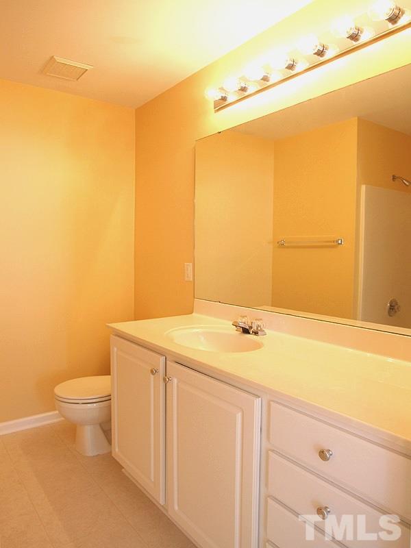8458 Reedy Ridge Lane Raleigh, NC 27613 - Photo 8 of 12 a bathroom with a sink and a toilet