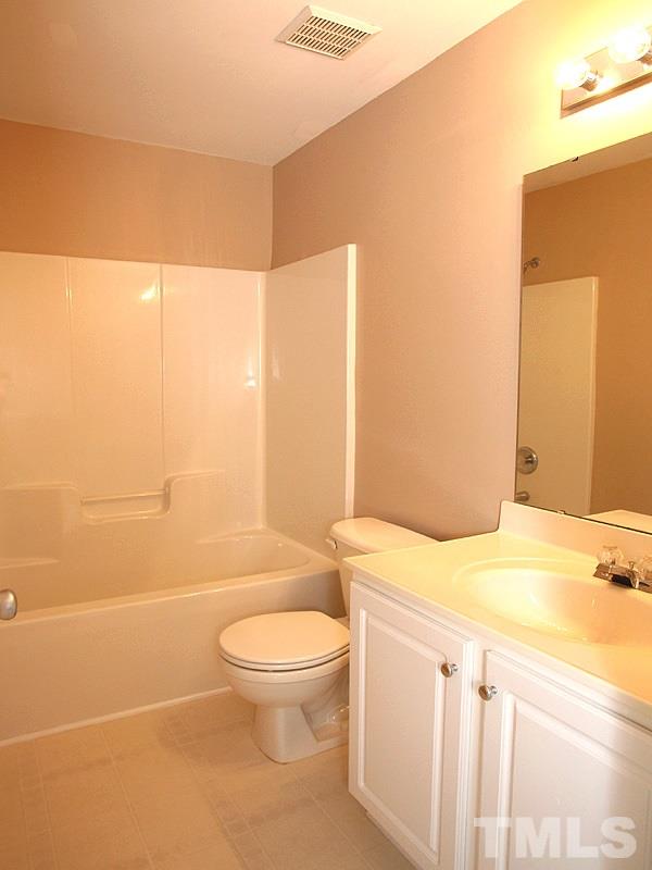 8458 Reedy Ridge Lane Raleigh, NC 27613 - Photo 10 of 12 a bathroom with a sink a toilet and shower