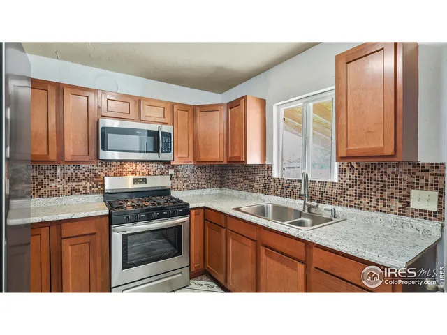 a kitchen with a stove sink and microwave