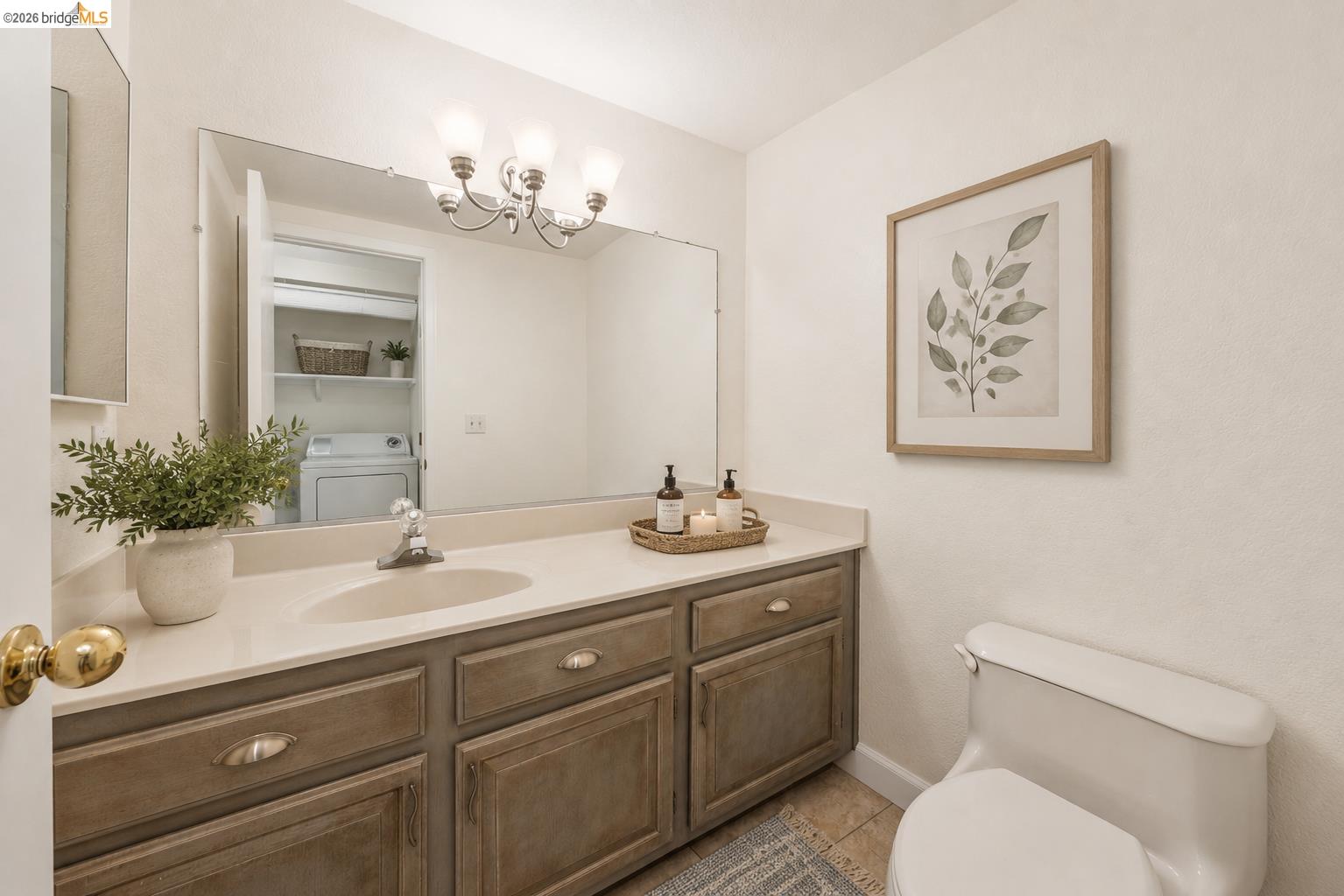 261 Redhawk Road Novato, CA 94949 - Photo 23 of 44 Bathroom featuring a single vanity with a light-toned countertop, integrated sink, and wood-finish cabinetry
