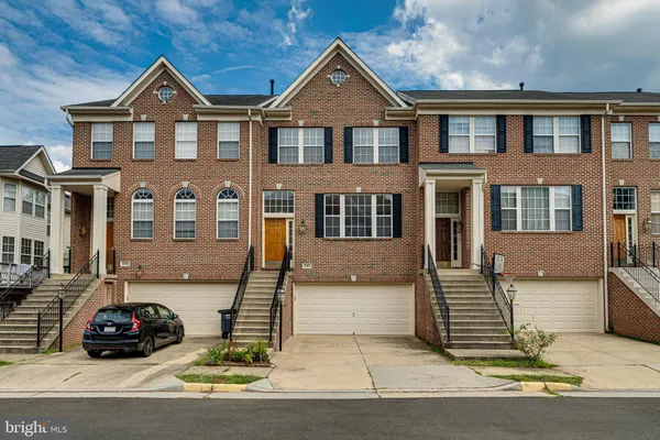 a car parked in front of a brick house