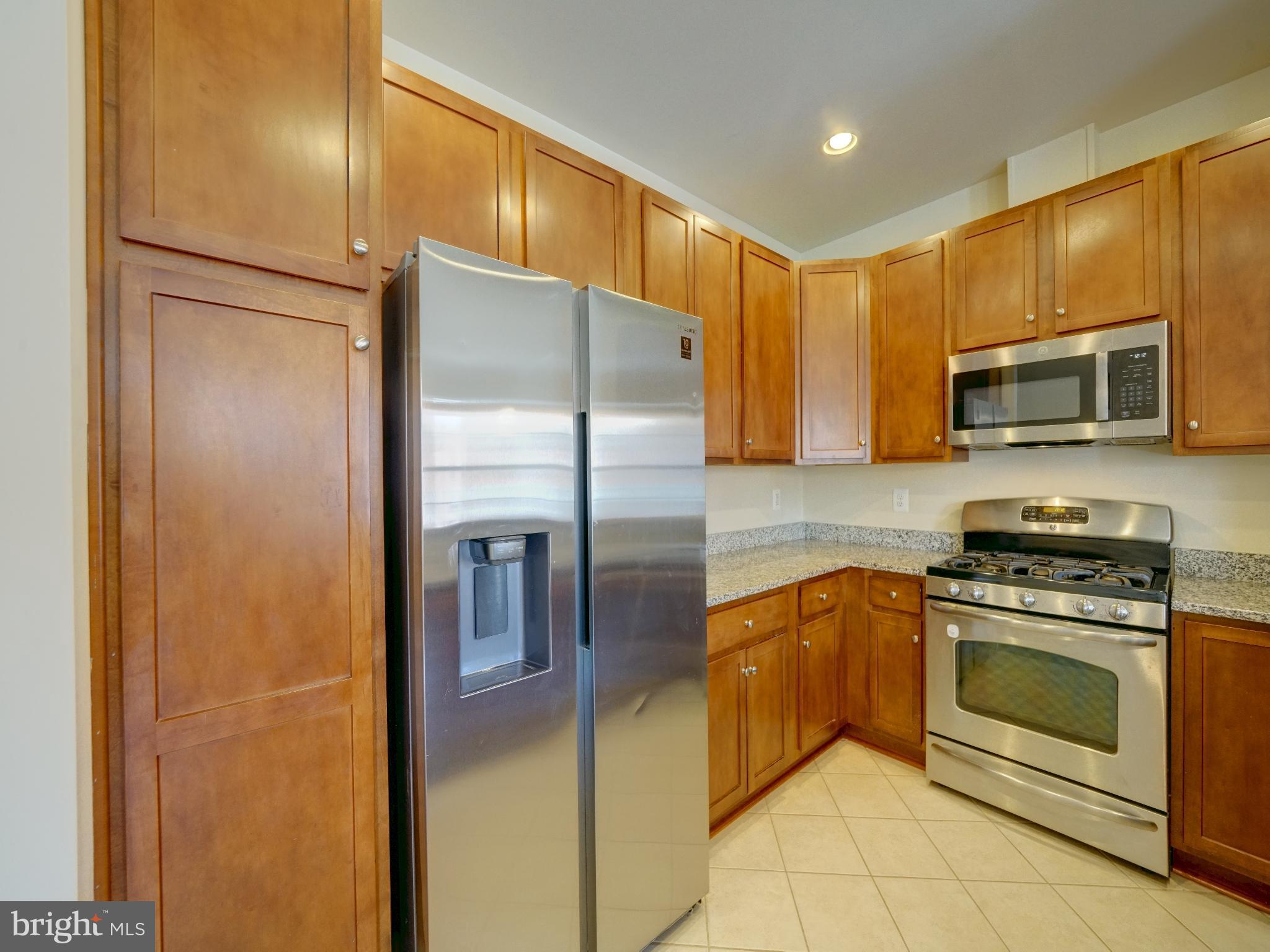 7672 Maple Lawn Boulevard, Unit 53 Fulton, MD 20759 - Photo 18 of 39 Modern kitchen with rich wood cabinetry.