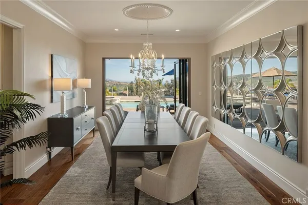 a view of a dining room with furniture and wooden floor