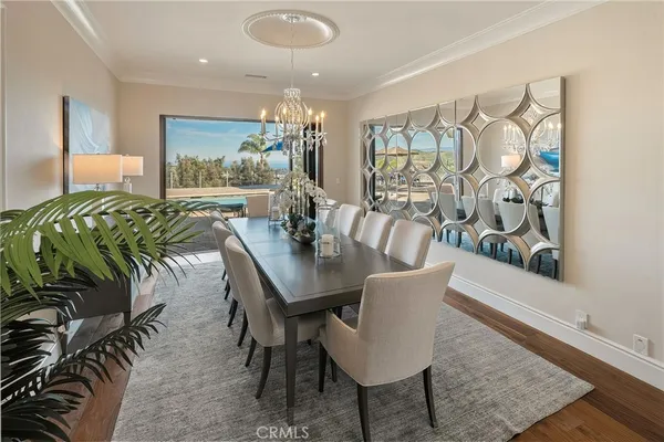 a kitchen with a sink a stove and chairs