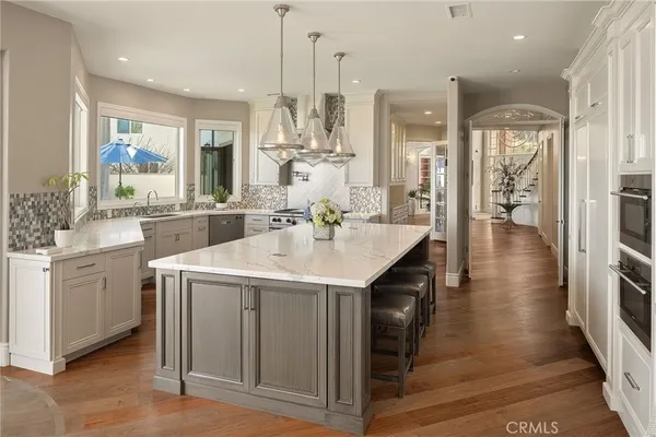 a kitchen with a table chairs sink and cabinets