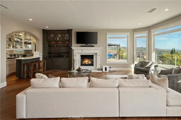 a living room with furniture fireplace and flat screen tv
