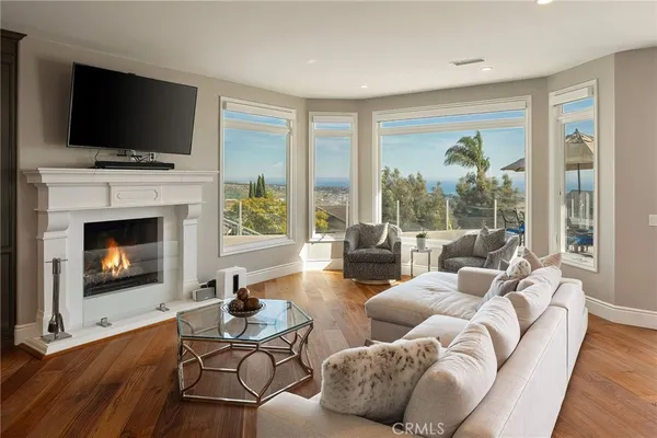 a living room with furniture tv and a fireplace