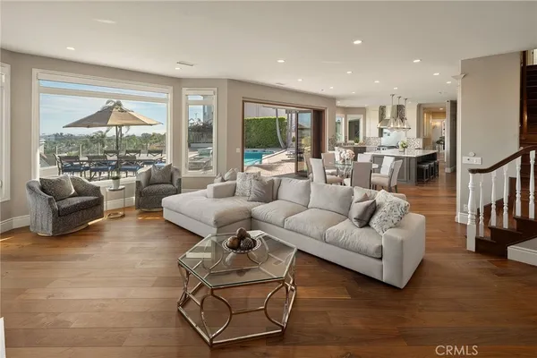 a view of a dining room with furniture wooden floor and a kitchen