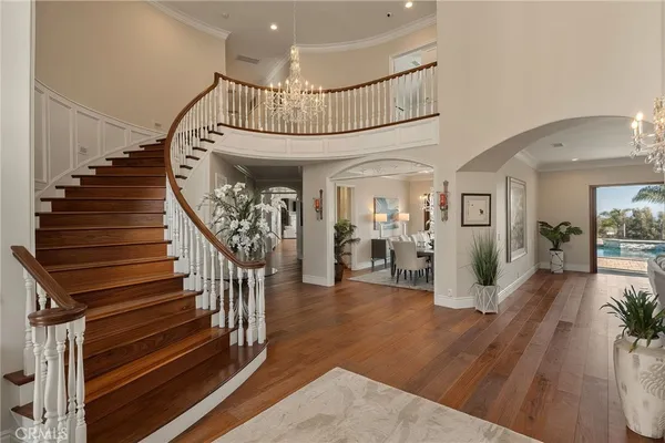 a view of entryway and hall with wooden floor
