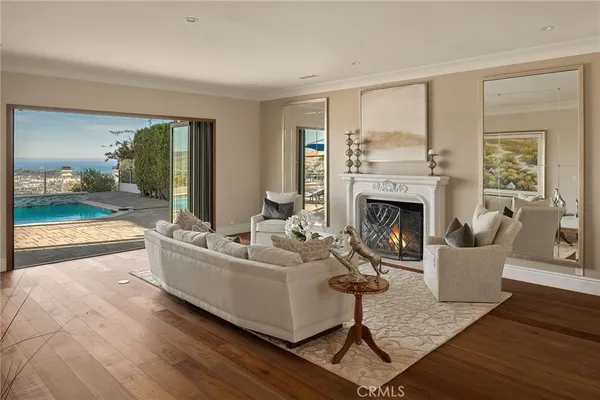 a living room with furniture and a floor to ceiling window