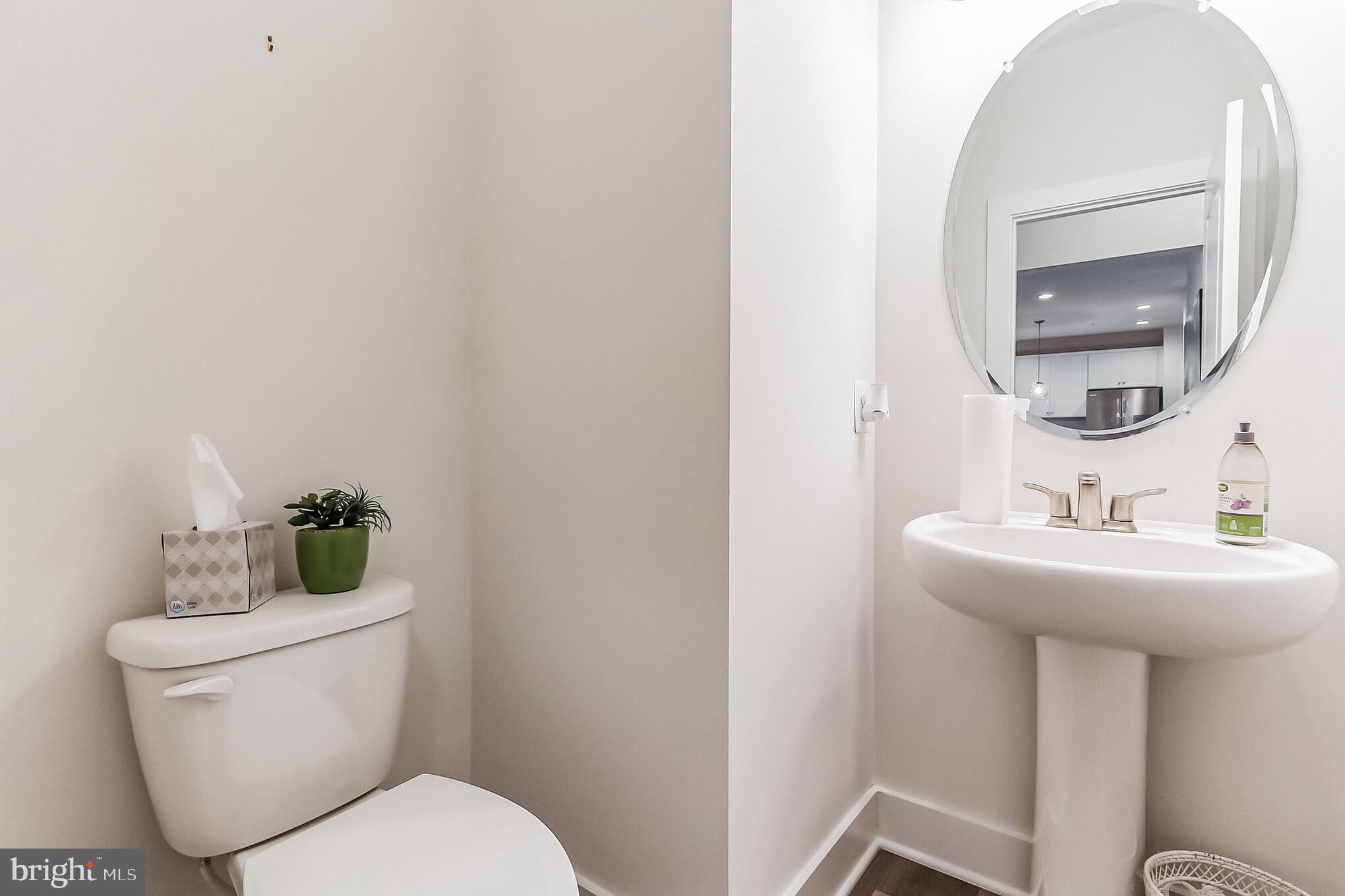 112 Red Rose Court Elkton, MD 21921 - Photo 4 of 10 a bathroom with a toilet a sink and mirror